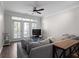 Bright living room featuring a ceiling fan, balcony access, and a comfortable gray sofa at 400 17Th Nw St # 2218, Atlanta, GA 30363