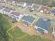 An aerial view of a house with a gray roof, patio, and fenced-in backyard in a neighborhood with surrounding homes and trees at 4349 Sublime Trl, Atlanta, GA 30349