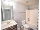 Clean bathroom featuring a toilet, shower/tub, sink, and dark brown vanity at 4349 Sublime Trl, Atlanta, GA 30349