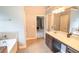 Bright bathroom vanity, shower and tub, and tiled floors at 4349 Sublime Trl, Atlanta, GA 30349
