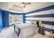 Primary bedroom featuring tray ceiling, large window, ceiling fan, and neutral carpet at 4349 Sublime Trl, Atlanta, GA 30349