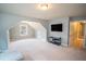 Spacious bonus room with unique windows, TV, and gray carpet at 4349 Sublime Trl, Atlanta, GA 30349