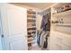 Organized walk-in closet with shelves, rods, drawers, and a door at 4349 Sublime Trl, Atlanta, GA 30349