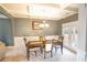 Inviting dining room featuring coffered ceilings, a modern chandelier, and a table set for four at 4349 Sublime Trl, Atlanta, GA 30349