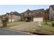 Attractive two-story brick home with a wide driveway and manicured front lawn at 4349 Sublime Trl, Atlanta, GA 30349