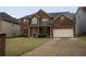 Charming two-story brick home with well-maintained lawn and a two-car garage at 4349 Sublime Trl, Atlanta, GA 30349