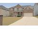 Beautiful two-story brick home with a well-kept lawn and attached two-car garage at 4349 Sublime Trl, Atlanta, GA 30349