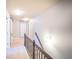 Hallway with carpeted flooring, light grey walls and dark wood railing at 4349 Sublime Trl, Atlanta, GA 30349