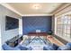 Well-appointed home office with a modern desk, accent wall, and ample natural light from a large window at 4349 Sublime Trl, Atlanta, GA 30349