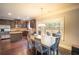A kitchen and dining area featuring stainless steel appliances, granite countertops, and hardwood floors at 4349 Sublime Trl, Atlanta, GA 30349