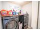 Well-organized laundry room featuring modern washer and dryer, complemented by storage and ample countertop space at 4349 Sublime Trl, Atlanta, GA 30349
