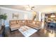 A large living room features a big sectional couch, hardwood flooring, and neutral paint at 4349 Sublime Trl, Atlanta, GA 30349