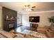A living room with a dark wood fireplace, mantle and hardwood flooring and leather couches at 4349 Sublime Trl, Atlanta, GA 30349