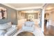 Open-concept living area with a dining room, featuring hardwood floors and a comfortable seating arrangement at 4349 Sublime Trl, Atlanta, GA 30349