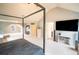 A bright main bedroom with modern furnishings, tv, carpeted floor and neutral walls at 4349 Sublime Trl, Atlanta, GA 30349