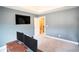 Spacious office with large TV and neutral color palette, creating a comfortable and productive work environment at 4349 Sublime Trl, Atlanta, GA 30349