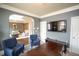 Spacious office featuring hardwood floors, a TV, and cozy blue armchairs for a comfortable workspace at 4349 Sublime Trl, Atlanta, GA 30349