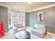 Cozy sitting room with bay windows, comfortable armchairs, and neutral tones, perfect for relaxation at 4349 Sublime Trl, Atlanta, GA 30349
