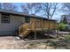 Back exterior shot of a newly constructed wooden deck with stairs leading to the yard at 6727 Kull Dr, Lithia Springs, GA 30122
