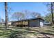 Back exterior of the house with a new wooden deck surrounded by a spacious yard at 6727 Kull Dr, Lithia Springs, GA 30122