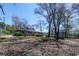 View of back yard with wood deck and storage building at 6727 Kull Dr, Lithia Springs, GA 30122