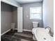 Bathroom featuring modern updates with a toilet, sink, stylish vanity, and updated floors at 6727 Kull Dr, Lithia Springs, GA 30122