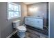 Bathroom featuring a modern toilet, double sink vanity, and ample natural light at 6727 Kull Dr, Lithia Springs, GA 30122
