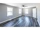 Bright bedroom with two large windows, ceiling fan, and hardwood flooring at 6727 Kull Dr, Lithia Springs, GA 30122