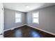 Sunlit bedroom with hardwood floors, two large windows, and a closet at 6727 Kull Dr, Lithia Springs, GA 30122