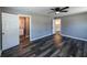 Spacious bedroom with hardwood floors, access to a bathroom, and ample natural light at 6727 Kull Dr, Lithia Springs, GA 30122