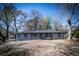 Charming one-story home with gray siding, dark roof, and well-maintained front yard at 6727 Kull Dr, Lithia Springs, GA 30122