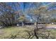 Exterior front shot of a house featuring a spacious yard and mature shade trees at 6727 Kull Dr, Lithia Springs, GA 30122