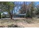 Charming single-story home with gray siding and inviting front yard, framed by mature trees offering ample shade at 6727 Kull Dr, Lithia Springs, GA 30122