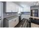 Contemporary kitchen featuring stainless appliances, granite countertops, and white cabinetry at 6727 Kull Dr, Lithia Springs, GA 30122