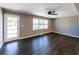 Bright living room featuring hardwood floors, a ceiling fan, and natural light at 6727 Kull Dr, Lithia Springs, GA 30122