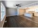 Open-concept living area with hardwood floors connecting to the kitchen with island at 6727 Kull Dr, Lithia Springs, GA 30122