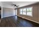 Hardwood floors in living room, with large window and access to the outside and kitchen at 6727 Kull Dr, Lithia Springs, GA 30122