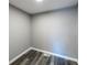 Empty room with hardwood floors, neutral walls, and baseboard trim at 6727 Kull Dr, Lithia Springs, GA 30122