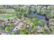 Aerial view of a home in a lakeside community with surrounding trees and a golf course nearby at 803 Amerden Ponds Ct, Johns Creek, GA 30097