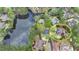 Overhead view showcasing the property, nearby lake, neighboring houses, and lush greenery at 803 Amerden Ponds Ct, Johns Creek, GA 30097