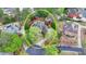 An aerial view showing the backyard and surrounding property, mature trees, and circular driveway at 803 Amerden Ponds Ct, Johns Creek, GA 30097