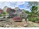 The house sits on beautifully landscaped grounds with lush greenery and a serene pond at 803 Amerden Ponds Ct, Johns Creek, GA 30097