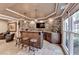 A home bar features stone accents, stylish pendants, and ample seating, perfect for entertaining guests at 803 Amerden Ponds Ct, Johns Creek, GA 30097
