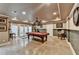 Finished basement with a pool table, tile floors, and a door leading to the outside at 803 Amerden Ponds Ct, Johns Creek, GA 30097