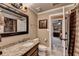 Bathroom featuring granite counters, a mirror with elegant lighting, and a view into the main bedroom at 803 Amerden Ponds Ct, Johns Creek, GA 30097