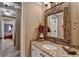 Charming bathroom features granite countertops, white cabinetry, decorative mirror, and elegant lighting at 803 Amerden Ponds Ct, Johns Creek, GA 30097