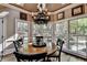 Bright breakfast nook featuring natural light through large bay windows overlooking the landscaped backyard at 803 Amerden Ponds Ct, Johns Creek, GA 30097