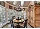 Cozy breakfast nook featuring multiple windows, hardwood floors, a chandelier, and lots of natural light at 803 Amerden Ponds Ct, Johns Creek, GA 30097