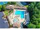 Aerial view of community pool, waterslides, and surrounding amenities with manicured grounds at 803 Amerden Ponds Ct, Johns Creek, GA 30097
