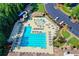 Aerial view of the community pool with a water slide and plenty of seating for residents at 803 Amerden Ponds Ct, Johns Creek, GA 30097